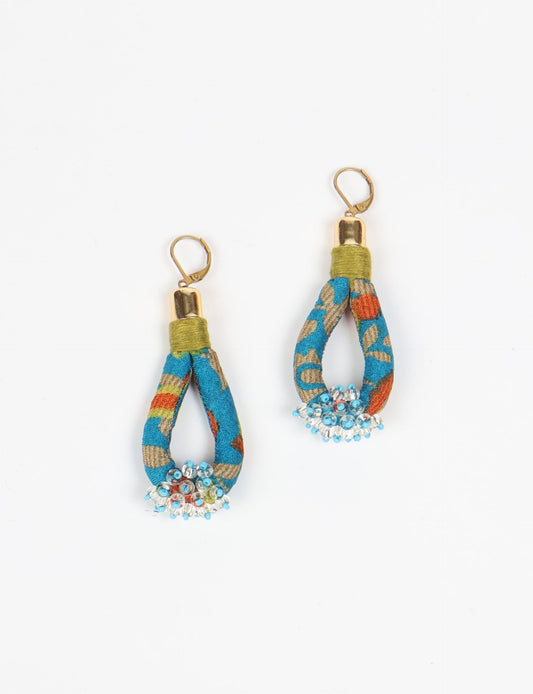 Discover the charm of Beaded Drop Earrings, meticulously crafted by Indian artisans. Recycled cotton rope, sari fabric, and surplus glass beads create an eco-friendly masterpiece. Hypoallergenic metal hooks ensure both style and comfort.