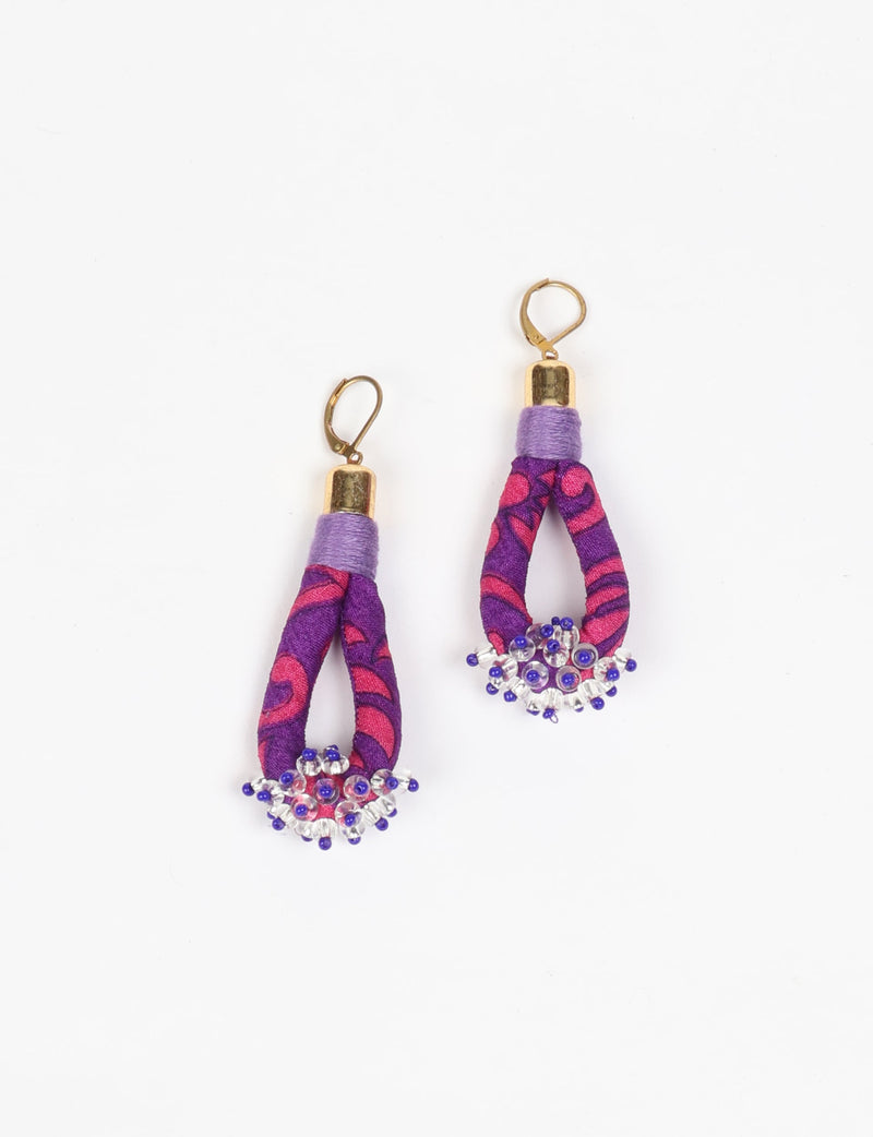 Purple and pink patterned fabric drop earrings with gold-tone hooks and clear and blue bead clusters at the bottom