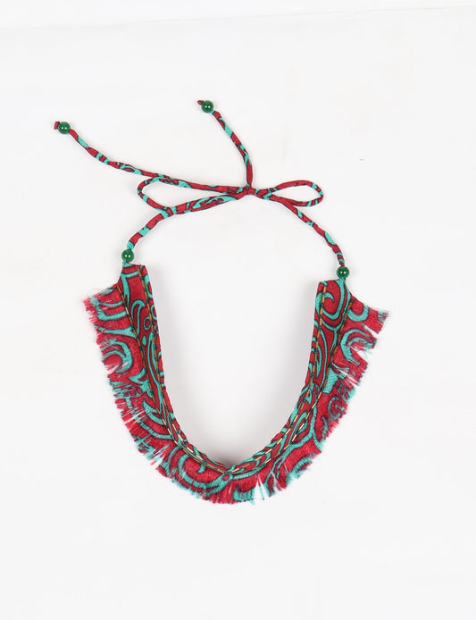 Discover the charm of our Tie-Up Fringe Choker, a meticulously crafted necklace with sari fringe edging and a tie-up back. Adorned with Indian salli beads by skilled female artisans in Mumbai, this accessory embodies ethical fashion and sustainable elegance.