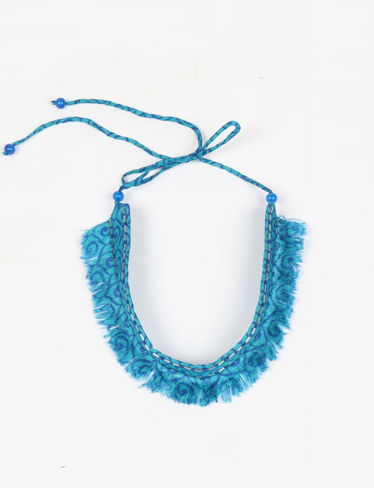 Discover the charm of our Tie-Up Fringe Choker, a meticulously crafted necklace with sari fringe edging and a tie-up back. Adorned with Indian salli beads by skilled female artisans in Mumbai, this accessory embodies ethical fashion and sustainable elegance.