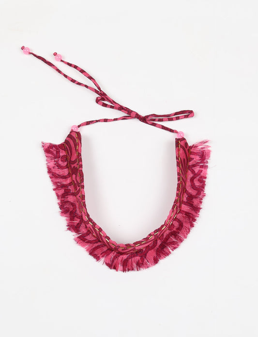 Discover the charm of our Tie-Up Fringe Choker, a meticulously crafted necklace with sari fringe edging and a tie-up back. Adorned with Indian salli beads by skilled female artisans in Mumbai, this accessory embodies ethical fashion and sustainable elegance.
