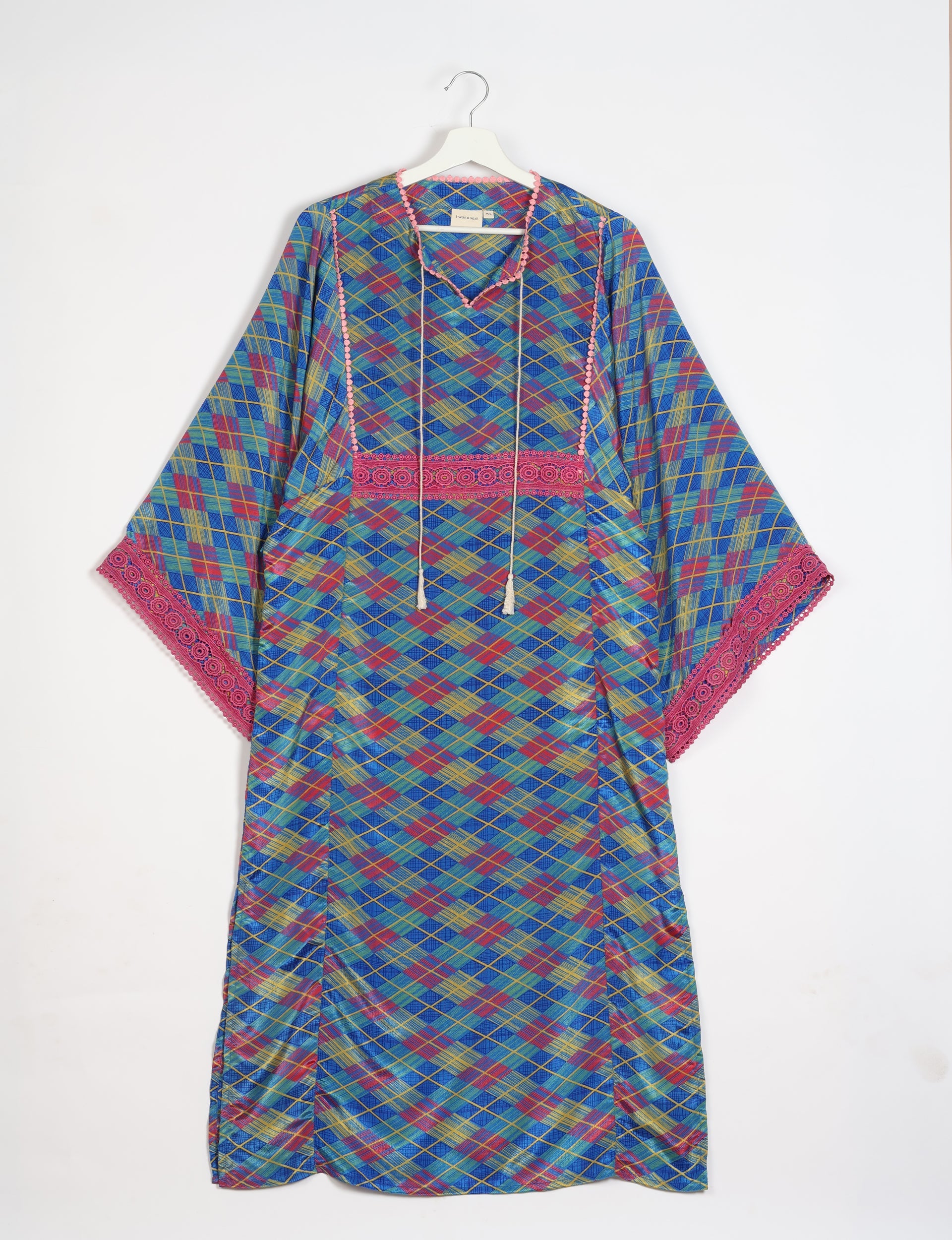 Blue geometric patterned maxi kaftan with pink lace trim on sleeves and neckline, hanging on white hanger front view