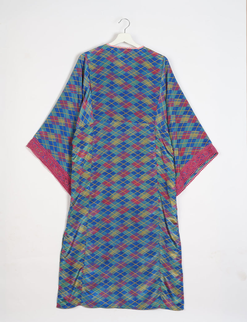 Blue maxi kaftan with multicolor geometric plaid pattern and pink lace trim on wide sleeves, shown hanging from white hanger