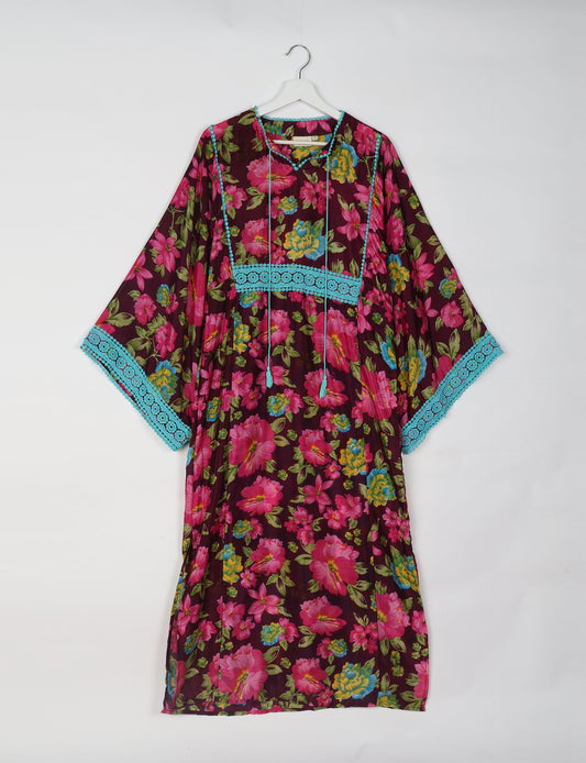 Maxi Kaftan with cotton lace on sleeves and midriff, featuring a tie-up neckline with tassels. Ankle-length, eco-friendly fashion made from recycled materials, offering sustainable women’s clothing for a chic, earth-friendly wardrobe.