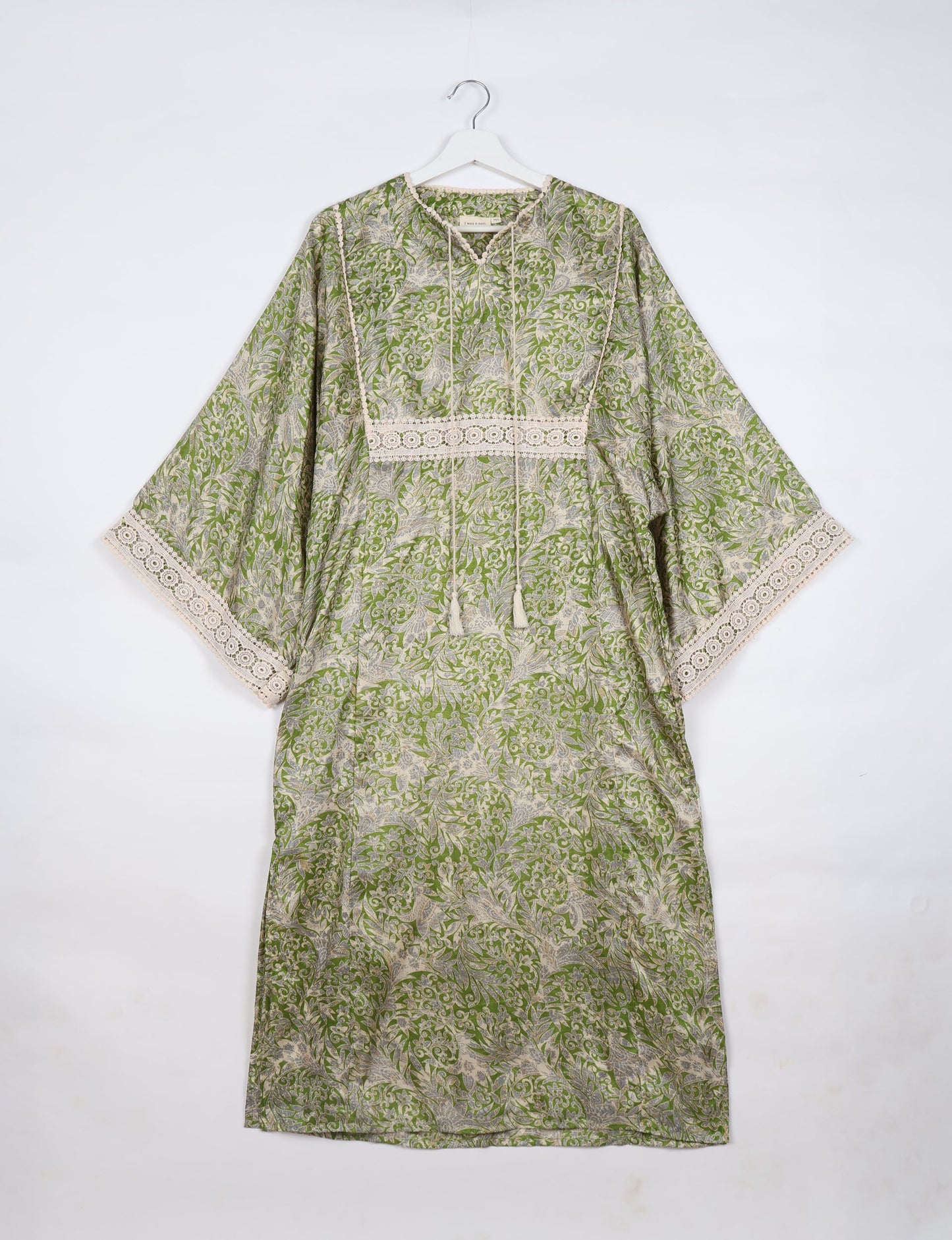 Maxi Kaftan with cotton lace on sleeves and midriff, featuring a tie-up neckline with tassels. Ankle-length, eco-friendly fashion made from recycled materials, offering sustainable women’s clothing for a chic, earth-friendly wardrobe.