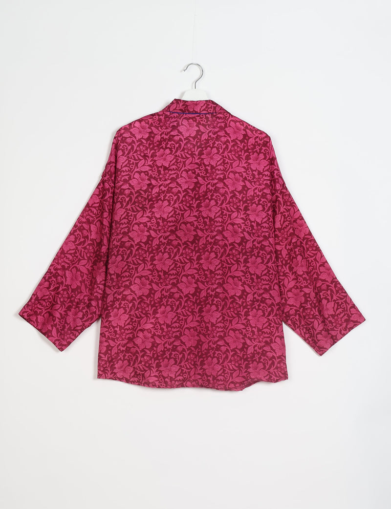 Oversized shirt in dark pink with bright pink floral pattern, long sleeves, and collar, shown from back on hanger