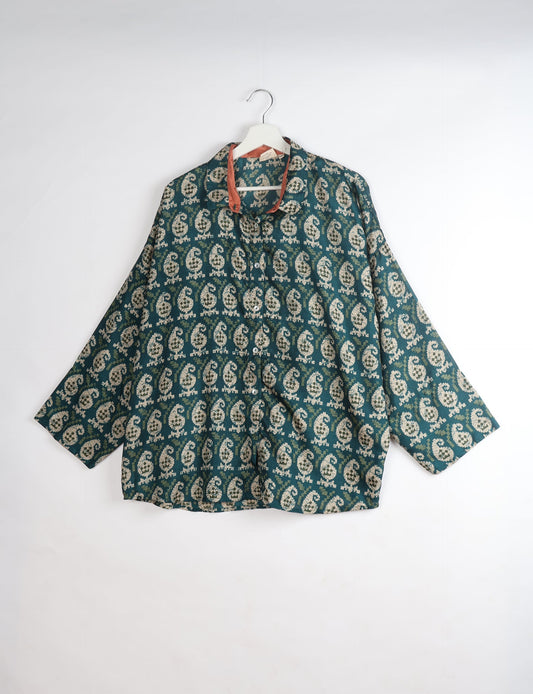 Experience chic comfort with our OVERSIZED SHIRT – a one-of-a-kind piece crafted from sari waste by talented Indian female artisans. With 3/4 length sleeves, a regular shirt collar, and a contrasting inner collar band, this shirt is perfect for work or casual hangouts. Versatile and stylish, it pairs effortlessly over a shift dress, jumpsuit, or with pants.