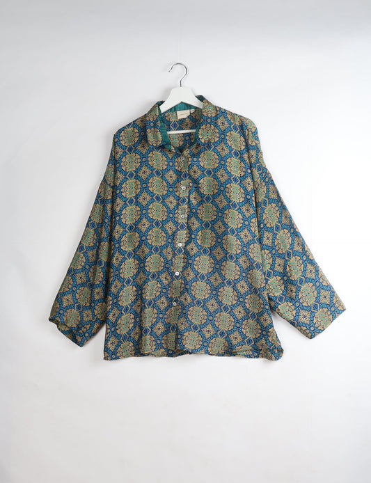 Experience chic comfort with our OVERSIZED SHIRT – a one-of-a-kind piece crafted from sari waste by talented Indian female artisans. With 3/4 length sleeves, a regular shirt collar, and a contrasting inner collar band, this shirt is perfect for work or casual hangouts. Versatile and stylish, it pairs effortlessly over a shift dress, jumpsuit, or with pants.