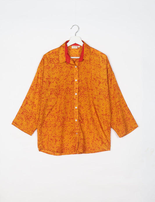 Experience chic comfort with our OVERSIZED SHIRT – a one-of-a-kind piece crafted from sari waste by talented Indian female artisans. With 3/4 length sleeves, a regular shirt collar, and a contrasting inner collar band, this shirt is perfect for work or casual hangouts. Versatile and stylish, it pairs effortlessly over a shift dress, jumpsuit, or with pants.