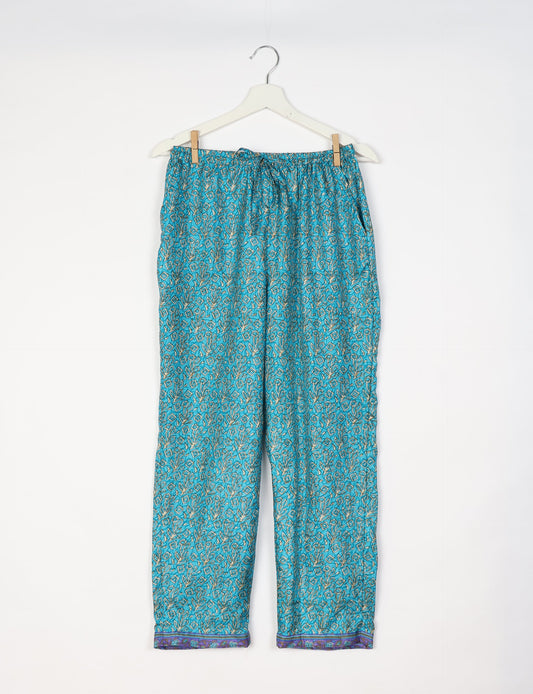 Elevate your wardrobe with our planet-friendly PULL-ON PANTS. Made from upcycled sari fabric, these eco-conscious pants offer a drawstring waist for a perfect fit. Tapered leg design ensures both style and comfort. Choose ethical, green fashion that supports artisans and sustainable living.