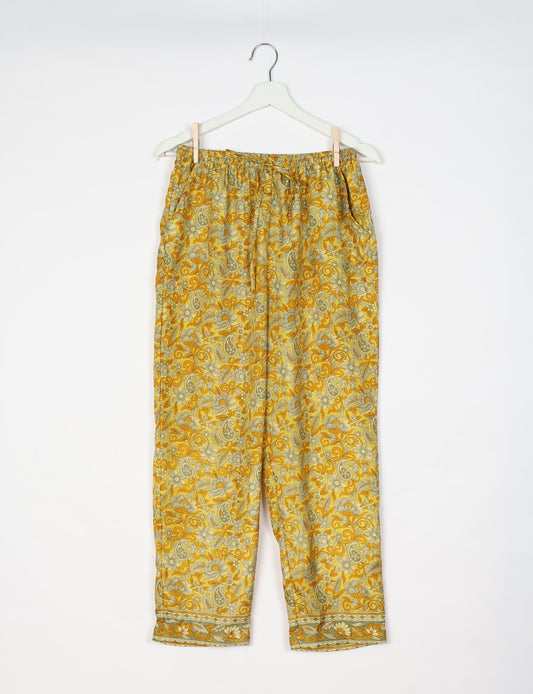 Elevate your wardrobe with our planet-friendly PULL-ON PANTS. Made from upcycled sari fabric, these eco-conscious pants offer a drawstring waist for a perfect fit. Tapered leg design ensures both style and comfort. Choose ethical, green fashion that supports artisans and sustainable living.