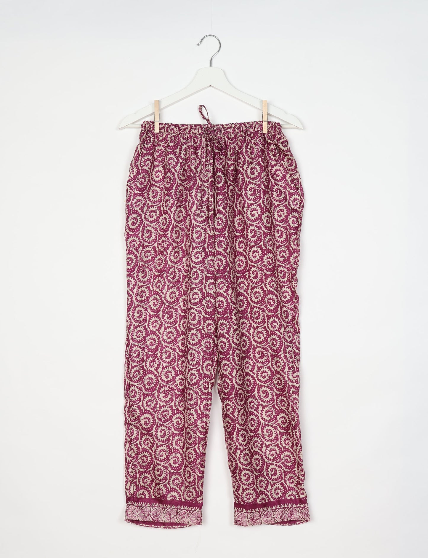 Elevate your wardrobe with our planet-friendly PULL-ON PANTS. Made from upcycled sari fabric, these eco-conscious pants offer a drawstring waist for a perfect fit. Tapered leg design ensures both style and comfort. Choose ethical, green fashion that supports artisans and sustainable living.