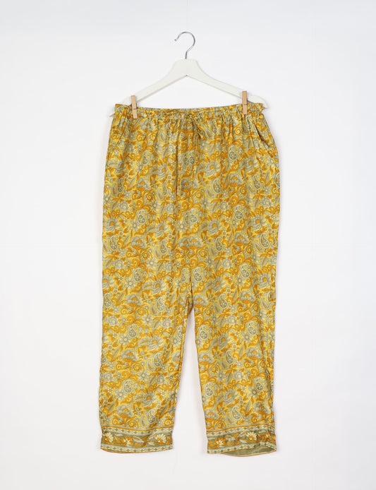 Elevate your wardrobe with our planet-friendly PULL-ON PANTS. Made from upcycled sari fabric, these eco-conscious pants offer a drawstring waist for a perfect fit. Tapered leg design ensures both style and comfort. Choose ethical, green fashion that supports artisans and sustainable living.