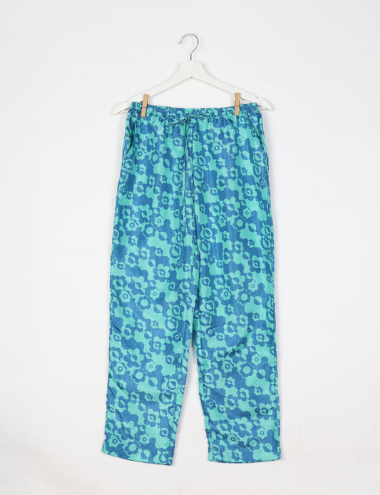 Elevate your wardrobe with our planet-friendly PULL-ON PANTS. Made from upcycled sari fabric, these eco-conscious pants offer a drawstring waist for a perfect fit. Tapered leg design ensures both style and comfort. Choose ethical, green fashion that supports artisans and sustainable living.