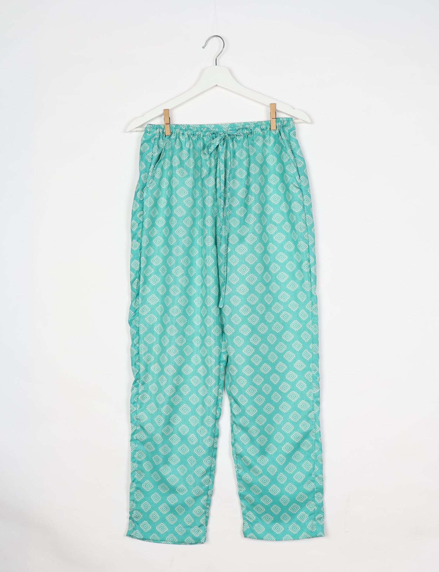 Elevate your wardrobe with our planet-friendly PULL-ON PANTS. Made from upcycled sari fabric, these eco-conscious pants offer a drawstring waist for a perfect fit. Tapered leg design ensures both style and comfort. Choose ethical, green fashion that supports artisans and sustainable living.