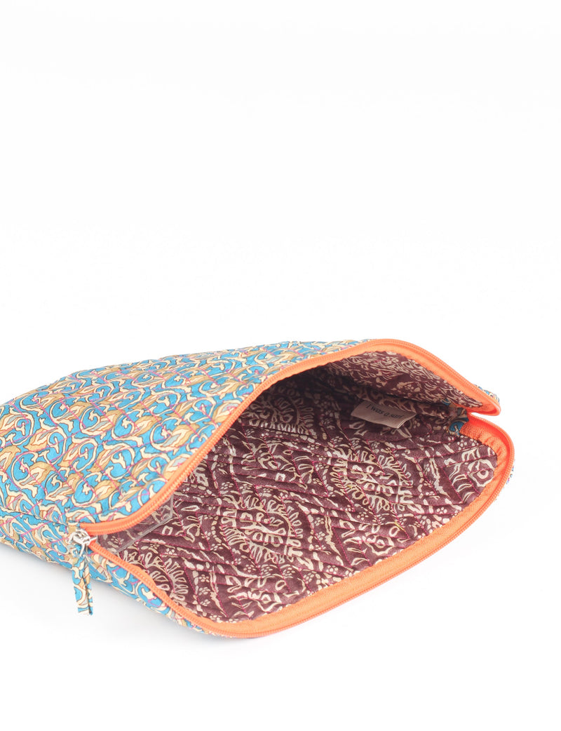 Quilted laptop sleeve with blue and beige floral micro design exterior and maroon patterned interior, orange zipper, open view