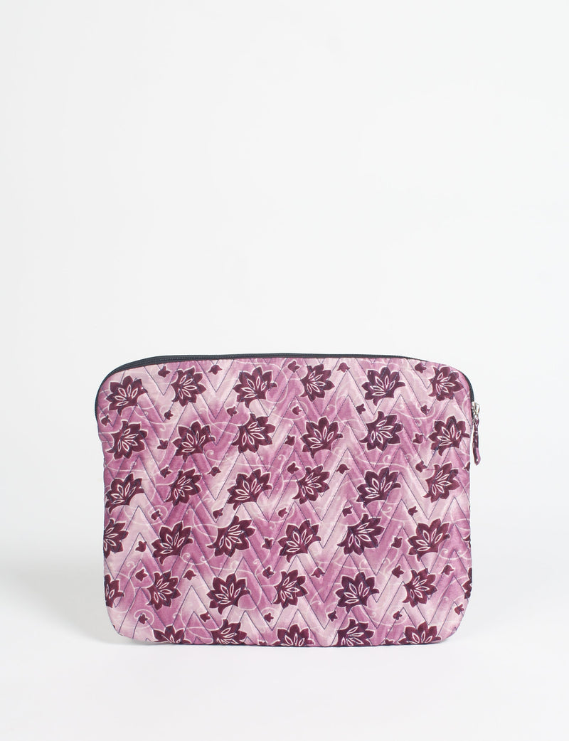 Quilted laptop sleeve with pink floral pattern and chevron stitching, shown flat with zipper closure at top edge