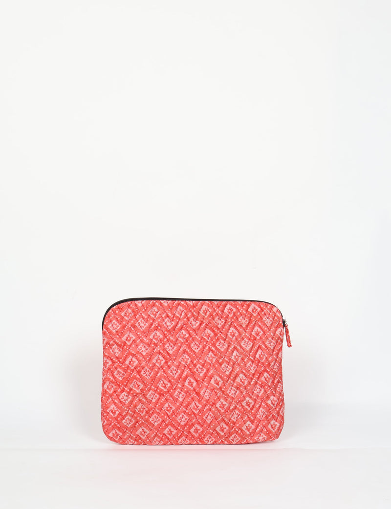 Quilted laptop sleeve in red with a chevron and floral pattern, black zipper, and flat front view on white background