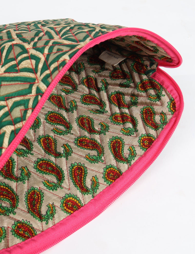 Quilted laptop sleeve with green paisley pattern exterior, red stitching, pink zipper, and multicolored paisley interior