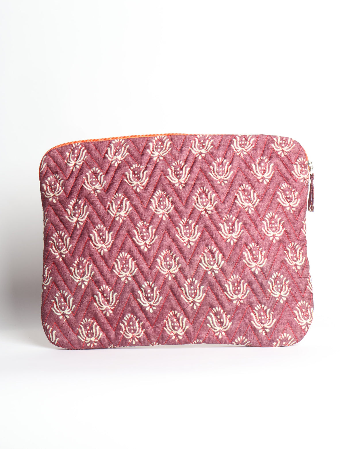 Quilted laptop sleeve with purple paisley pattern, blue zipper, and rounded corners, shown flat on white background