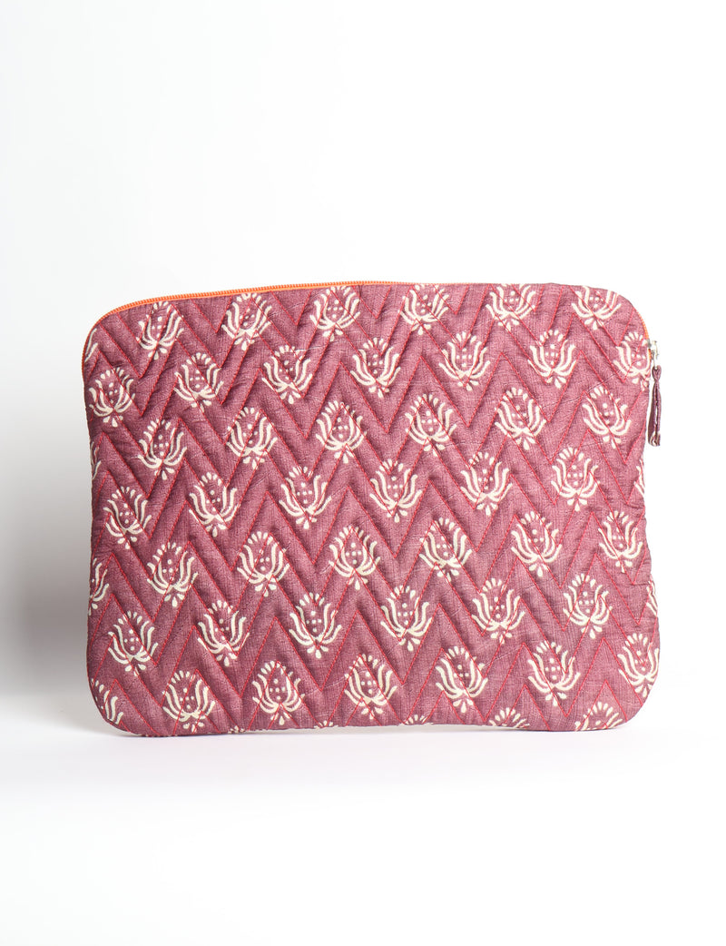 Quilted laptop sleeve with purple paisley pattern, blue zipper, and rounded corners, shown flat on white background