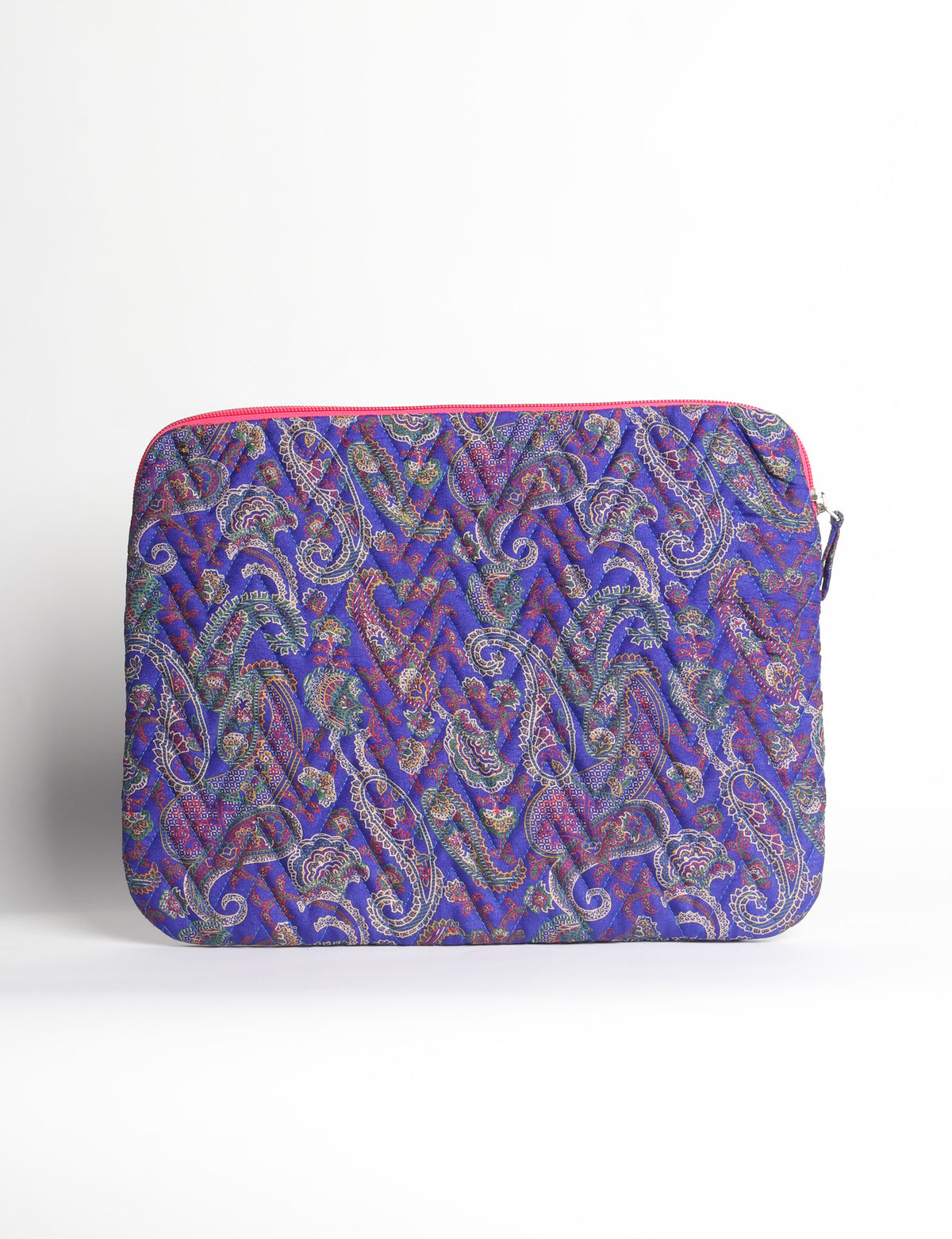 Quilted laptop sleeve with purple paisley pattern, blue zipper, and rounded corners, shown flat on white background