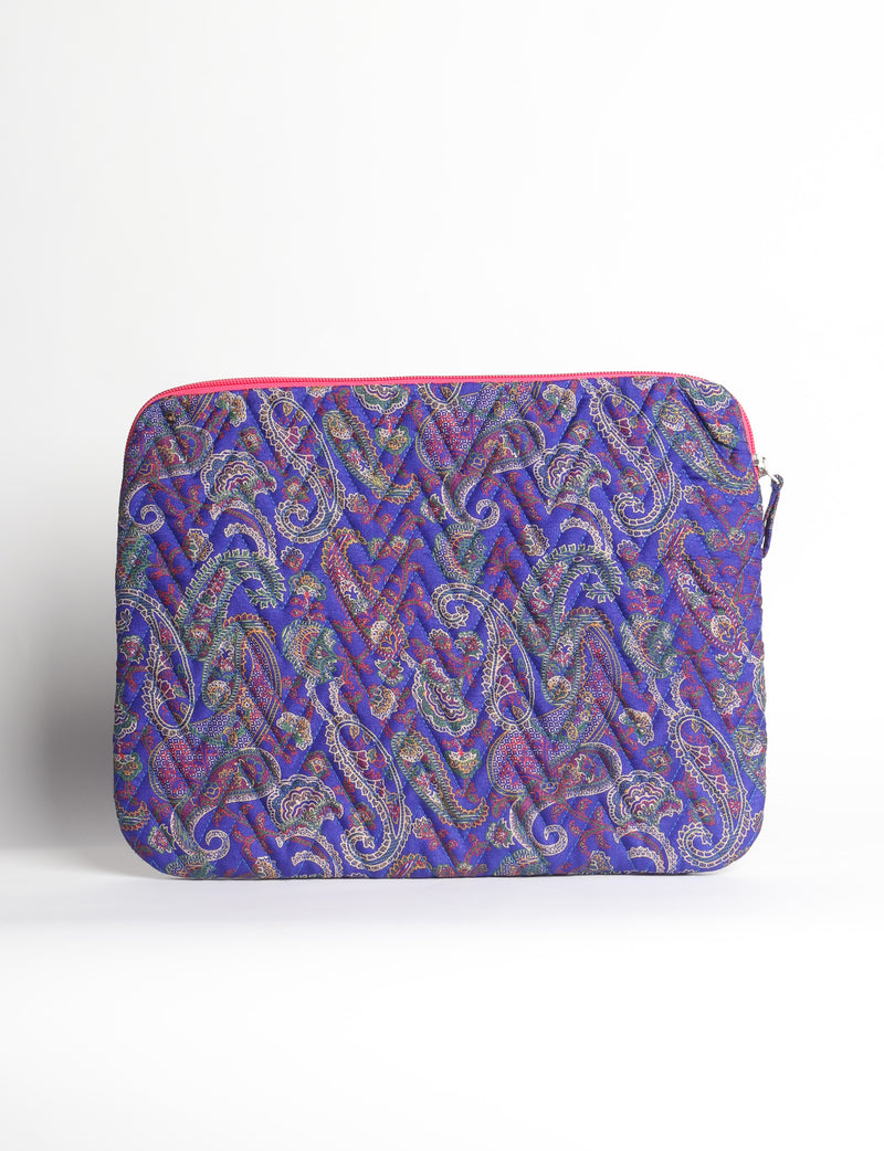 Quilted laptop sleeve with purple paisley pattern, blue zipper, and rounded corners, shown flat on white background