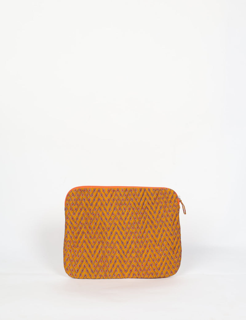 Quilted laptop sleeve with yellow fabric and small red and blue floral micro design, front view, standing upright