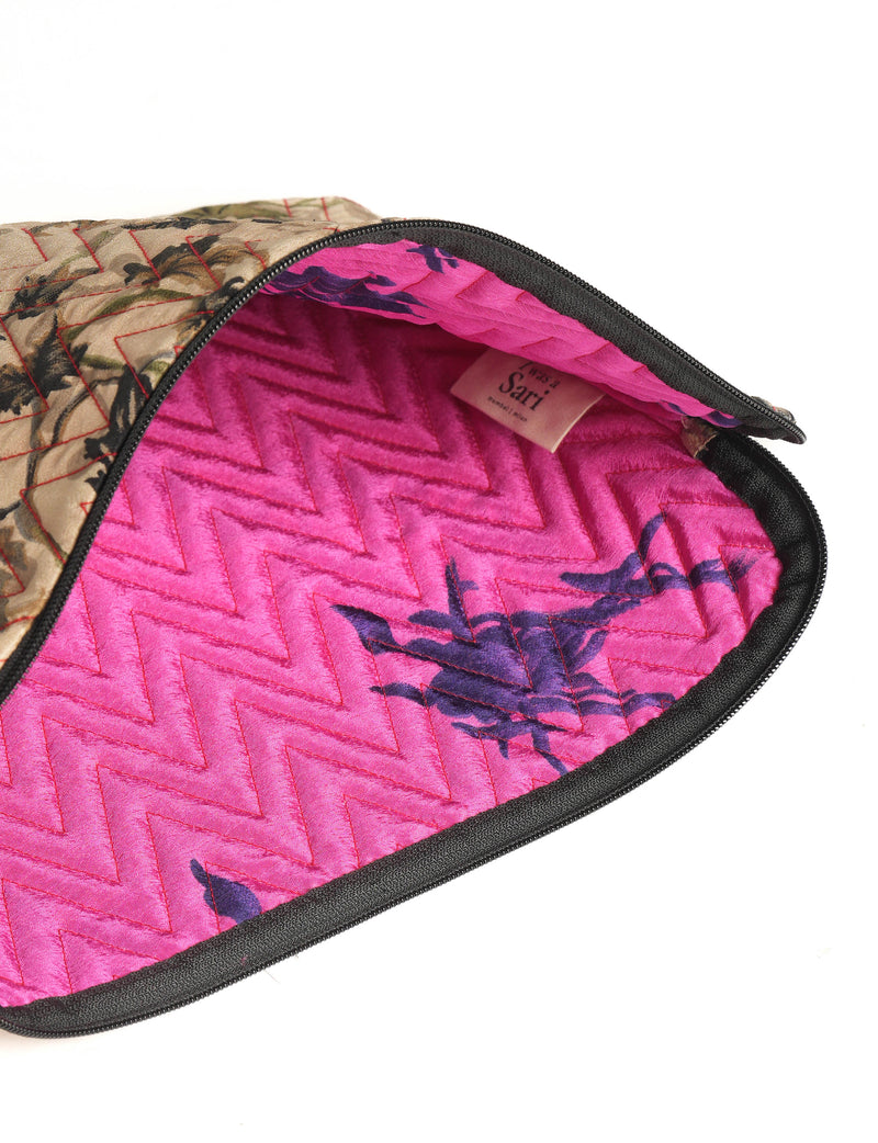 Quilted beige floral laptop sleeve with pink quilted interior and black zipper, partially open showing label inside