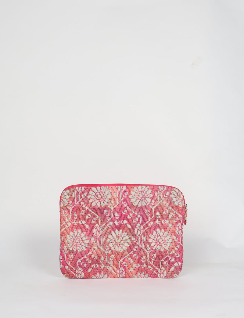 Quilted laptop sleeve with pink floral and chevron pattern, front view, zipper closure, standing on white background