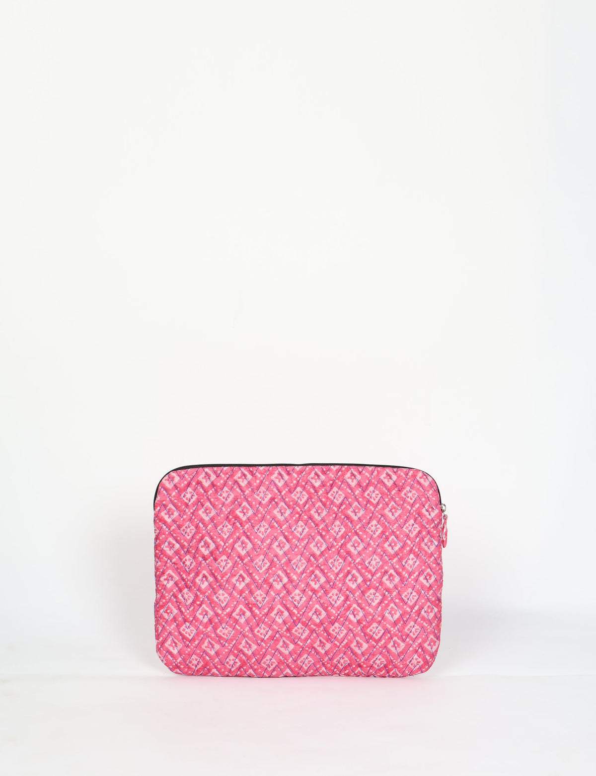 Quilted laptop sleeve in pink with geometric pattern, zipper closure, shown front view on white background