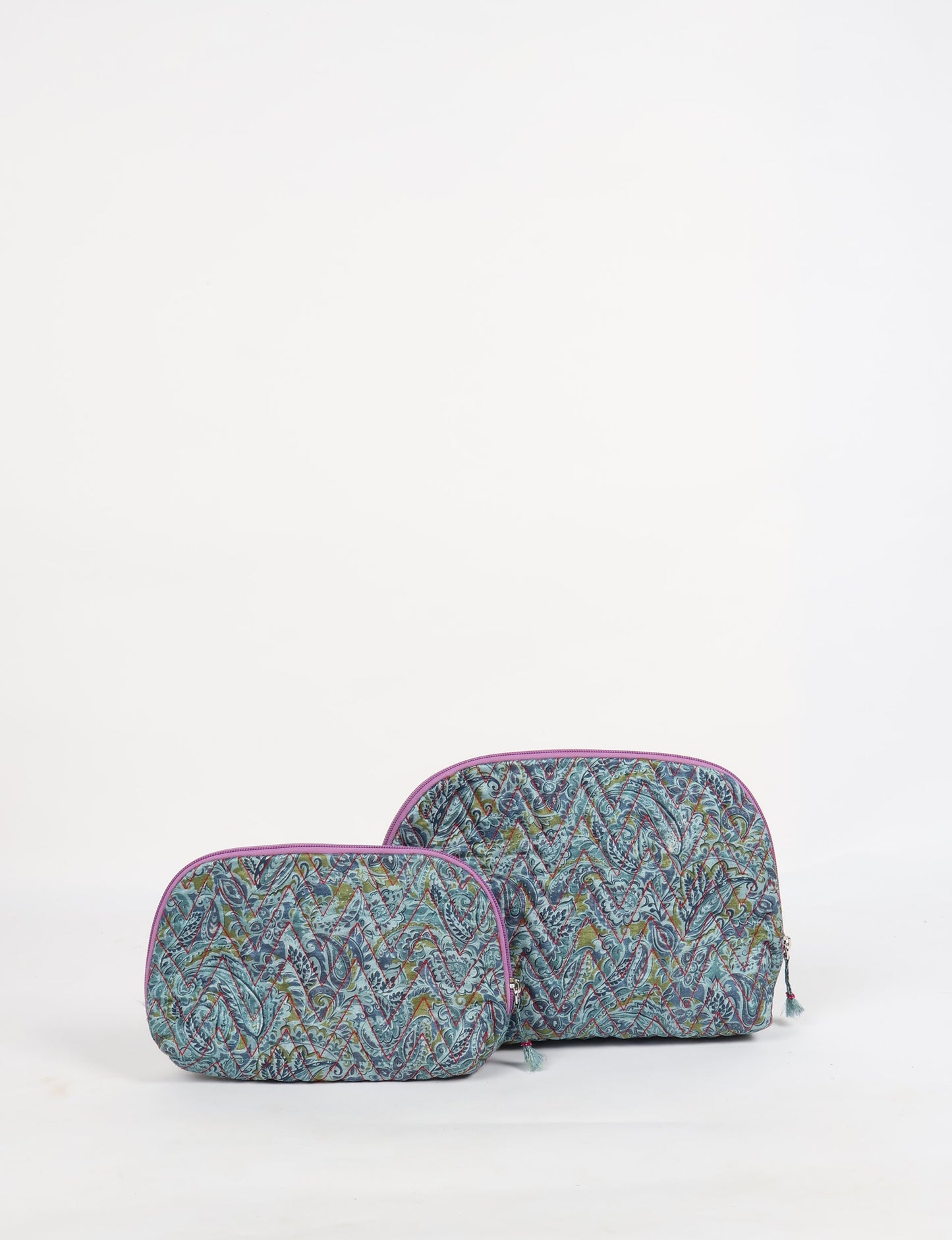 A set of two Vanity Pouches, featuring embellished beaded pullers, made from sustainable materials for eco-conscious travelers.