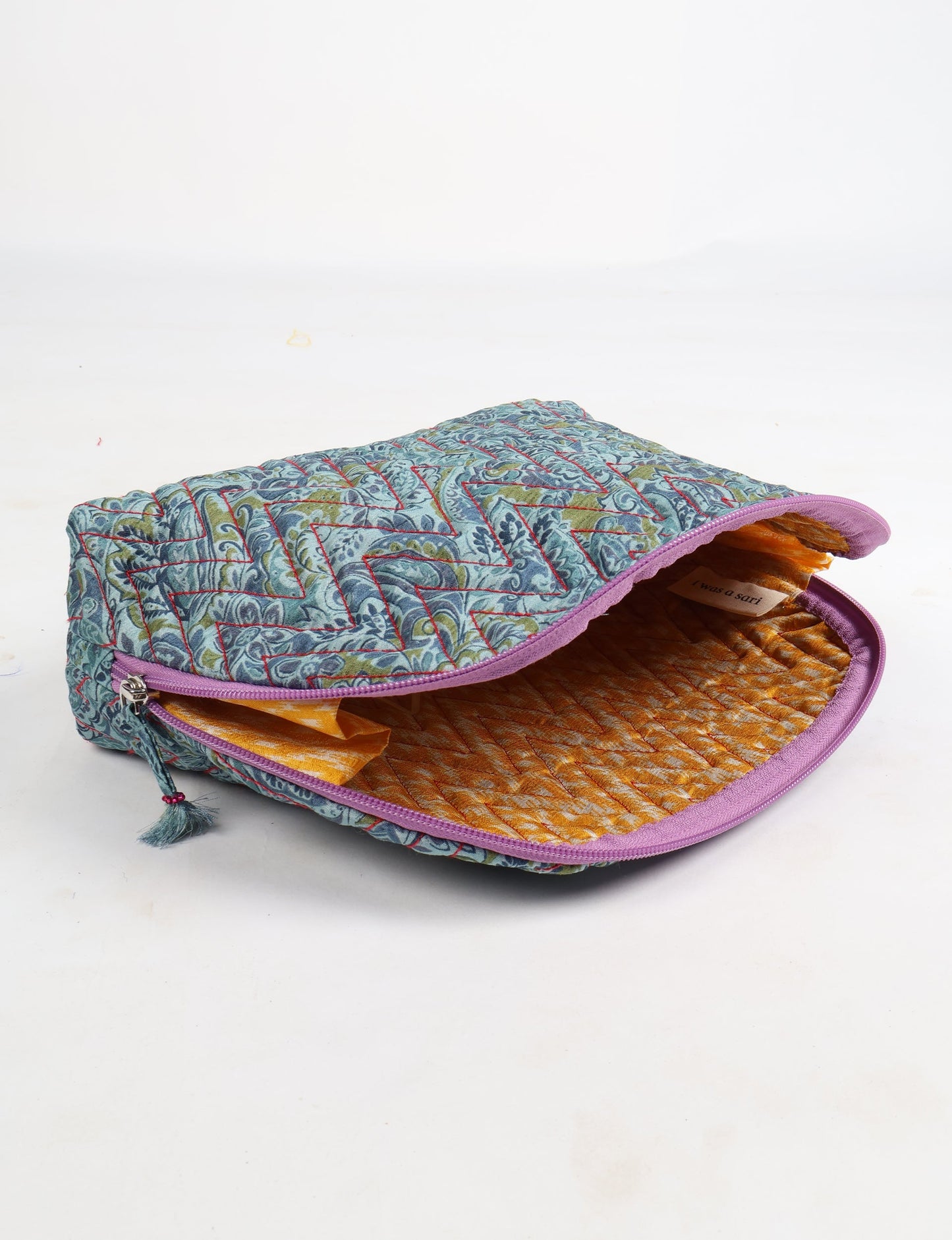 A set of two Vanity Pouches, featuring embellished beaded pullers, made from sustainable materials for eco-conscious travelers.