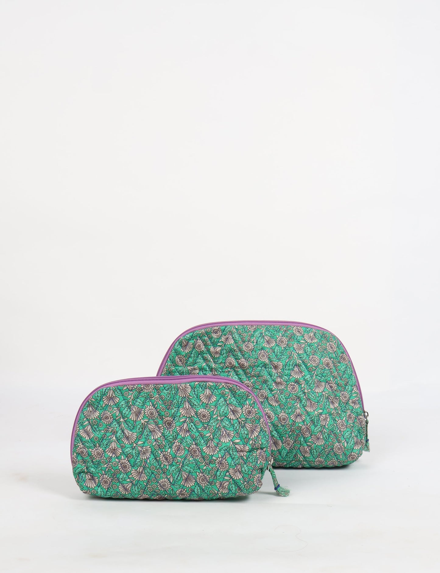A set of two Vanity Pouches, featuring embellished beaded pullers, made from sustainable materials for eco-conscious travelers.
