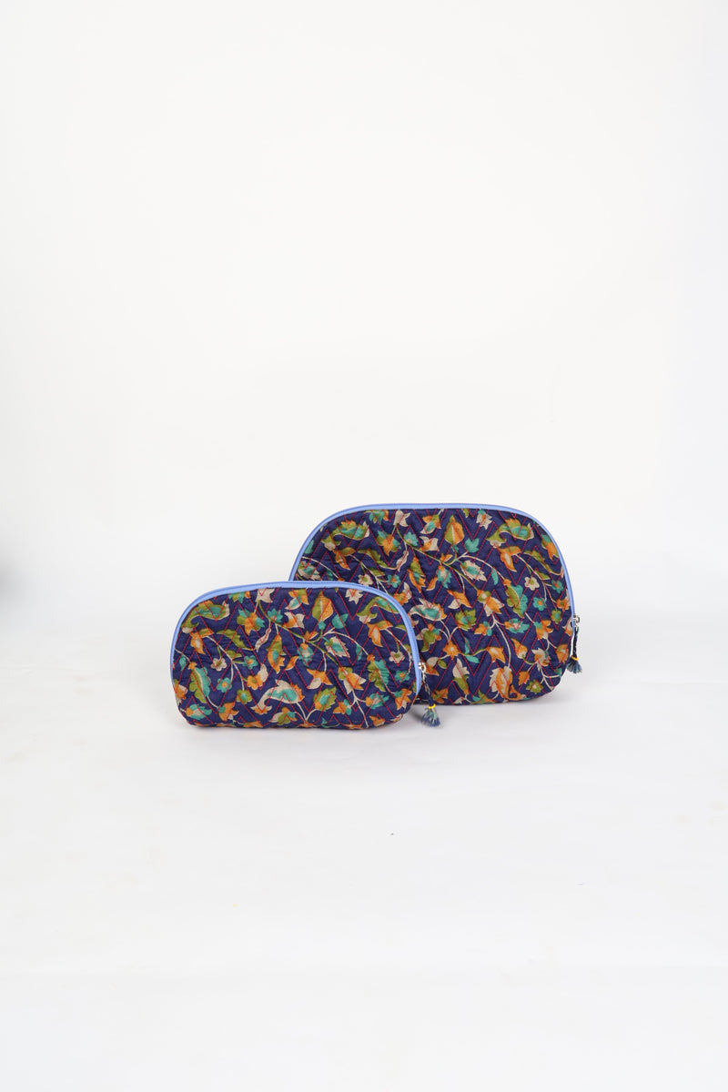 Blue tropical quilted cotton vanity pouch set with zipper and tassel details, front view, standing on white background