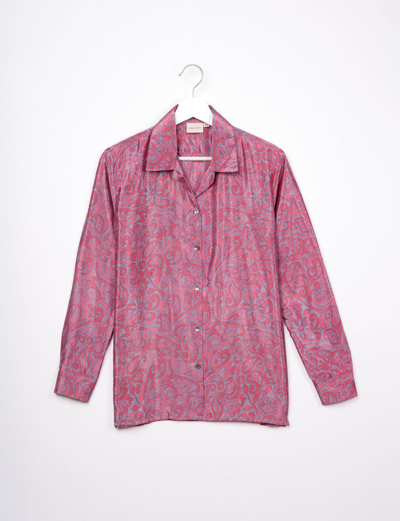 Long-sleeve pink floral resort shirt with button front and spread collar hanging on white hanger against white background