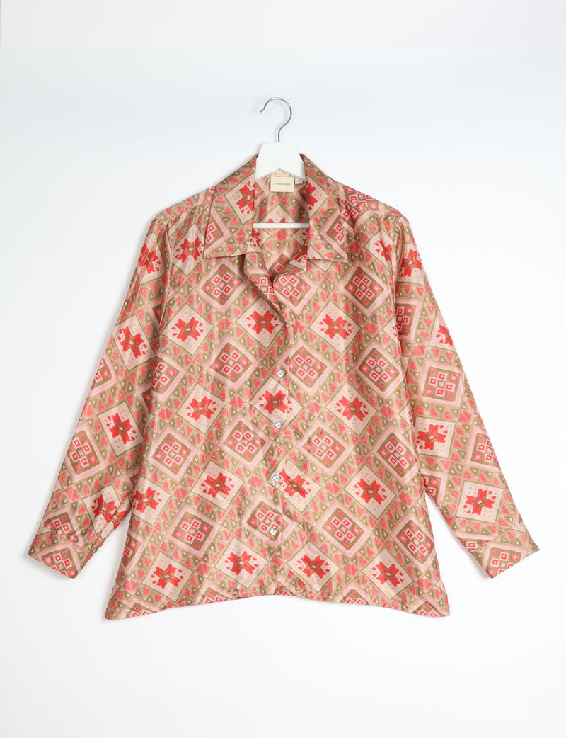 Beige resort shirt with red and pink Indian ethnic diamond and floral pattern, long sleeves, button front, on hanger flat lay