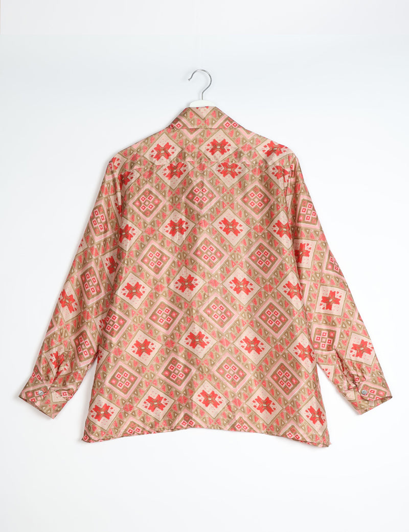 Beige resort shirt with red and pink Indian ethnic diamond and floral patterns, long sleeves, shown from back on hanger