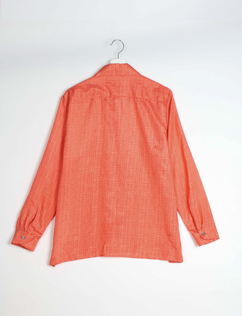 Orange resort shirt with abstract pattern, long sleeves, buttoned cuffs, shown from back on hanger