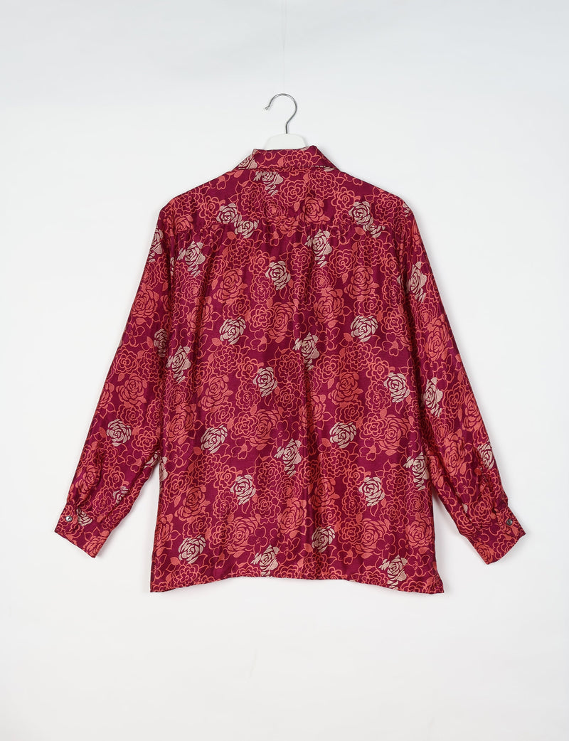 Long-sleeve pink floral resort shirt with buttoned cuffs, shown from back on white hanger against white background
