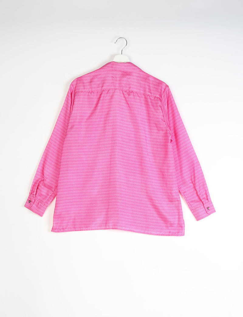 Red tropical patterned long-sleeve resort shirt shown from the back, hanging on a white hanger against a white background
