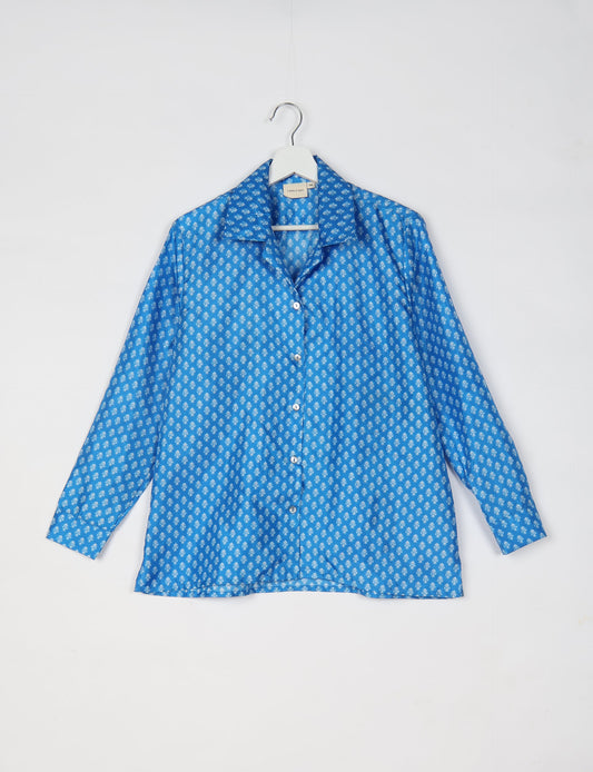 A person wearing a Resort Shirt, a sustainable fashion choice made from recycled materials.