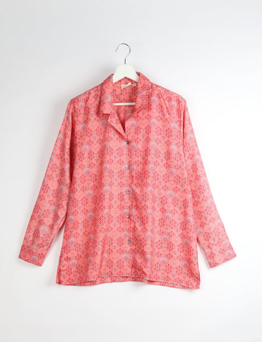 A person wearing a Resort Shirt, a sustainable fashion choice made from recycled materials.