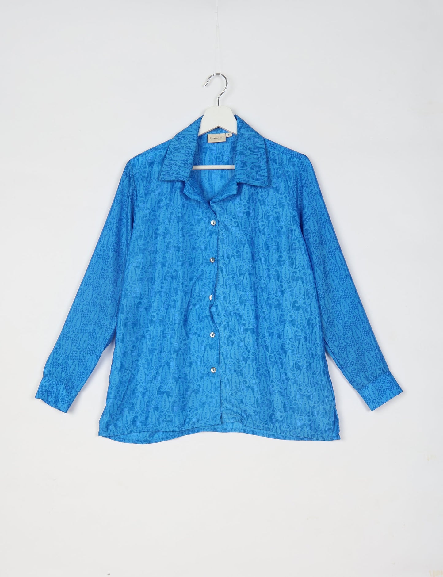 A person wearing a Resort Shirt, a sustainable fashion choice made from recycled materials.