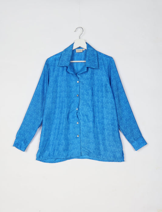 A person wearing a Resort Shirt, a sustainable fashion choice made from recycled materials.