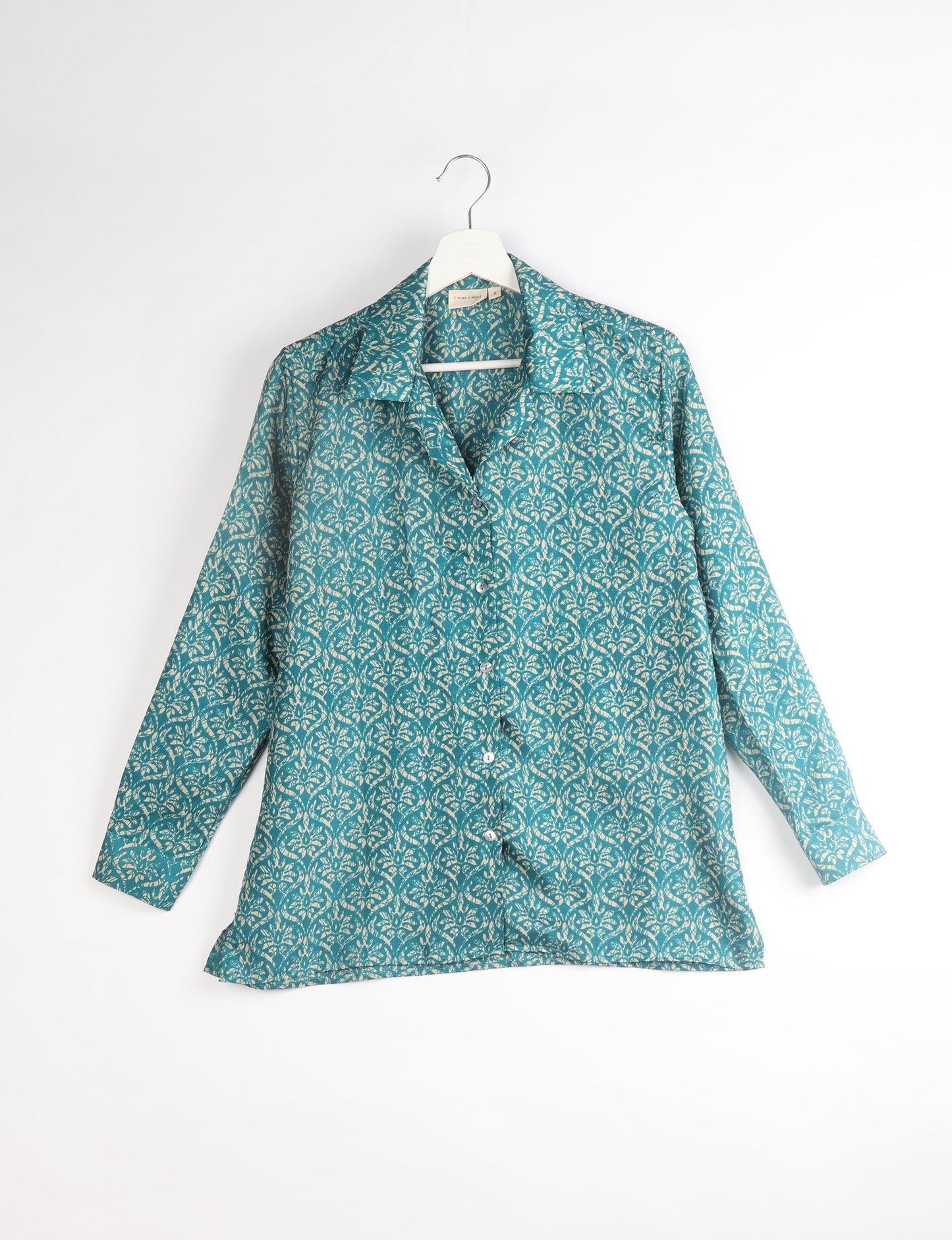 A person wearing a Resort Shirt, a sustainable fashion choice made from recycled materials.