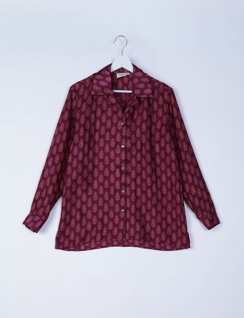 Red long-sleeve resort shirt with beige micro leaf pattern, button front, spread collar, hanging on white hanger, front view