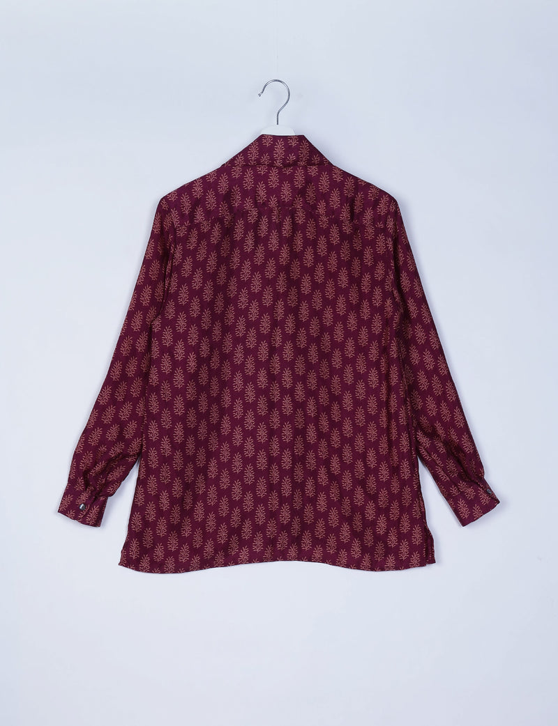 Red long-sleeve resort shirt with beige micro leaf pattern, buttoned cuffs, shown from back on white hanger