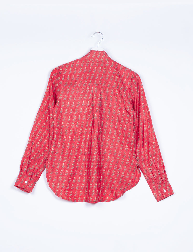 Long-sleeve orange shirt with small floral pattern, buttoned cuffs, shown from back on white hanger against white background