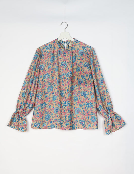 Flowing blouse with peasant sleeves and gathered neckline made from upcycled garments and repurposed clothing, showcasing eco clothing and fair trade fashion in a stylish, comfortable design.